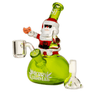 Close-up three-quarter view of the lime-green Smokin' Santa Bong featuring a Santa figure holding a cookie and wearing sunglasses atop the round body.